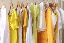 Yellow clothes hanging in a closet