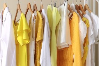 Yellow clothes hanging in a closet