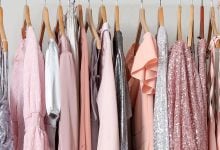 Pink clothes hanging in a closet