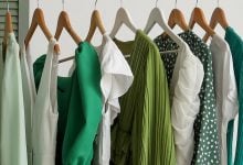 Green clothes hanging in a cloest