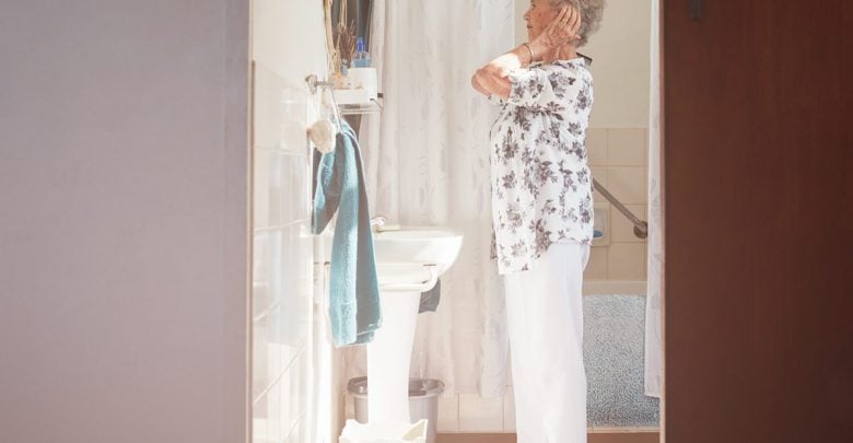 mature women over 50 standing in front of the mirror getting ready