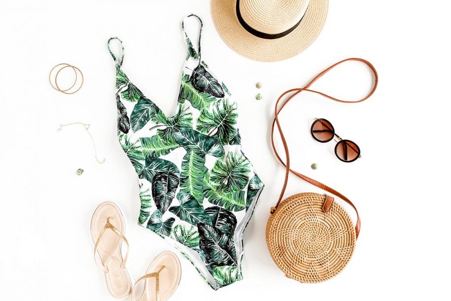 Flat lay of swimsuit and summer accessories