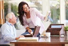 Adult daughter looking at photos with her dad