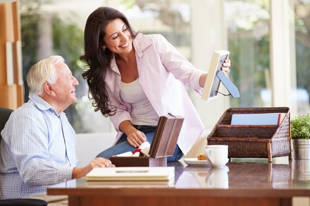 Adult daughter looking at photos with her dad