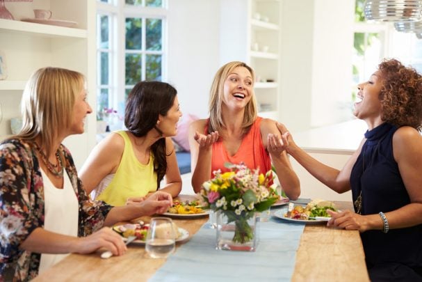 4 woman sitting at a table: the 4 types of body language and what they say about you