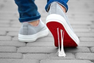 Person walking as gum gets stuck to the bottom of their shoe. What keeps you stuck?