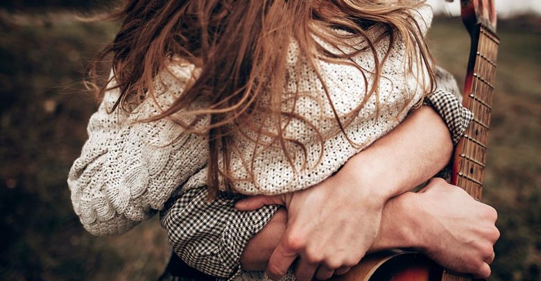 Woman being scooped up in a big hug