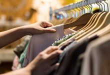 Woman shopping for clothes on a rack at the store