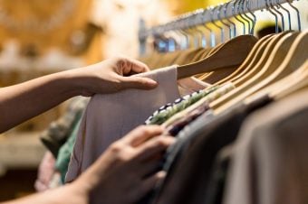 Woman shopping for clothes on a rack at the store