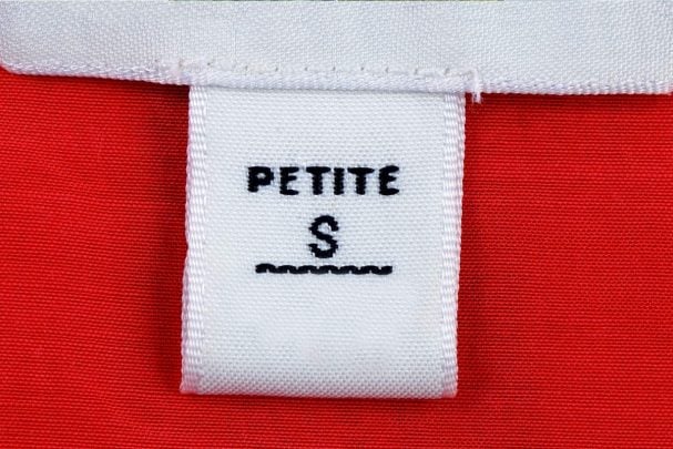 White Petite S tag on red clothing: How to dress to flatter a petiti figure