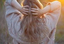 The woman with her hands in her young-looking hair