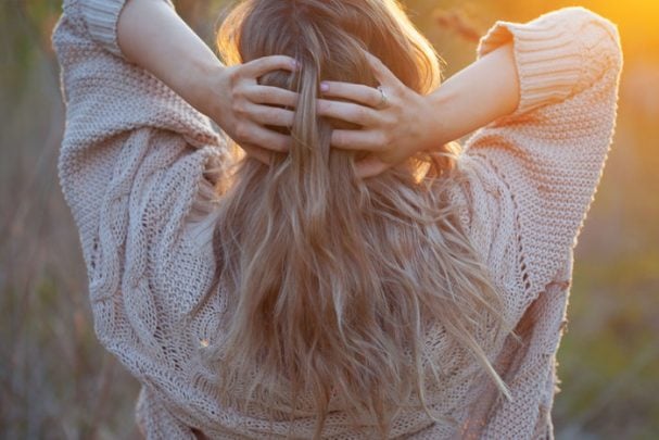 The woman with her hands in her young-looking hair