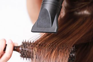 image of hair being round brushed and blown dry
