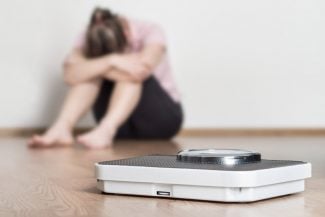 How each Type of woman shames her body - woman feeling ashamed next to a scale