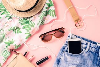 Summer capsule wardrobe checklist - sunglasses, floral shirt, jean shorts