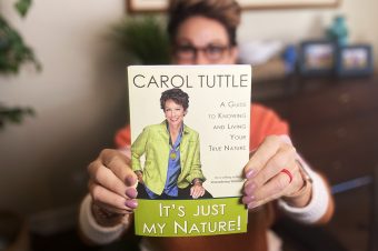 Carol Tuttle holding her book It's Just My Nature