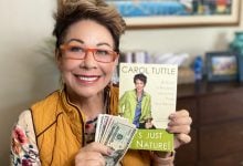 Carol Tuttle holding money with the book It's Just My Nature