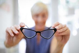 Woman holding up glasses