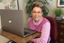 Carol in front of her laptop - how to look great on zoom
